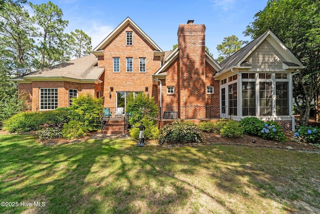 30 Spring Valley Ct, Pinehurst, NC 28374 - back of house with brick siding, a sunroom, a lawn, and a chimney