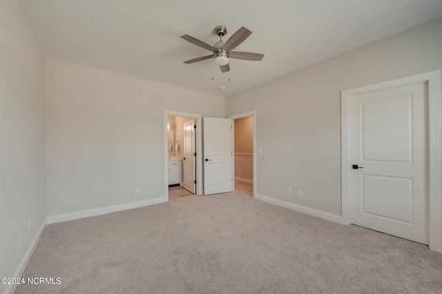 2125 Kali Ln Unit A, Greenville, NC 27834 - unfurnished bedroom featuring light colored carpet, baseboards, connected bathroom, a spacious closet, and a ceiling fan