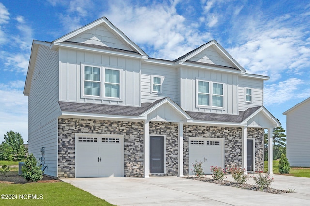 2125 Kali Ln Unit A, Greenville, NC 27834 - view of front of property featuring board and batten siding, a garage, concrete driveway, and stone siding