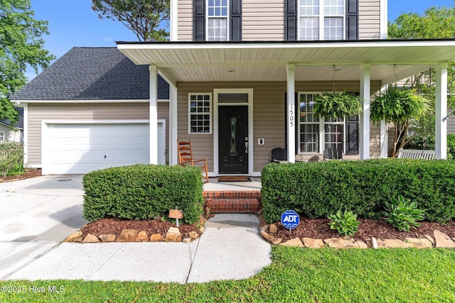 1505 Faulkenberry Rd, Wilmington, NC 28409 - view of exterior entry featuring covered porch, an attached garage, and concrete driveway