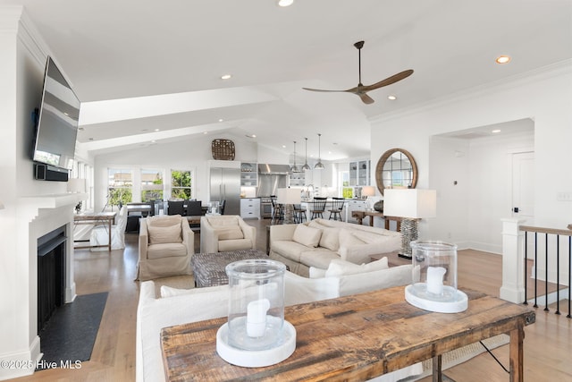 585 Forest Dunes Dr, Pine Knoll Shores, NC 28512 - living room with ceiling fan, lofted ceiling, recessed lighting, light wood-style floors, and ornamental molding