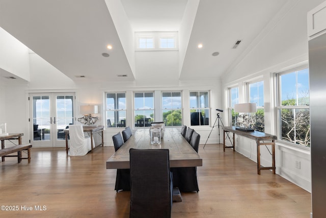 585 Forest Dunes Dr, Pine Knoll Shores, NC 28512 - dining space with high vaulted ceiling, plenty of natural light, wood finished floors, french doors, and recessed lighting