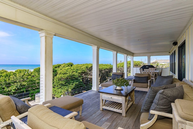 585 Forest Dunes Dr, Pine Knoll Shores, NC 28512 - sunroom featuring wood-type flooring, outdoor lounge area, a water view, and healthy amount of natural light