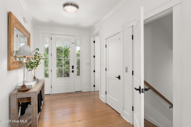 585 Forest Dunes Dr, Pine Knoll Shores, NC 28512 - foyer with light wood-style floors and crown molding