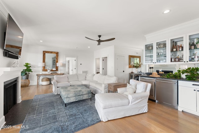 585 Forest Dunes Dr, Pine Knoll Shores, NC 28512 - living room with a fireplace, a ceiling fan, recessed lighting, ornamental molding, and wood finished floors