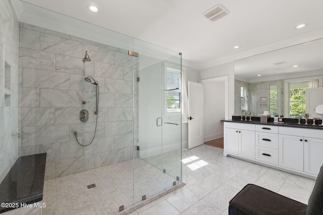 585 Forest Dunes Dr, Pine Knoll Shores, NC 28512 - full bath featuring ornamental molding, a shower stall, double vanity, plenty of natural light, and recessed lighting