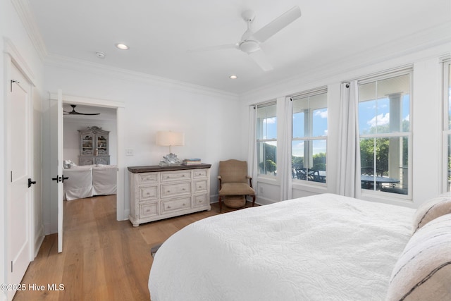 585 Forest Dunes Dr, Pine Knoll Shores, NC 28512 - bedroom featuring multiple windows, ornamental molding, light wood-type flooring, recessed lighting, and a ceiling fan