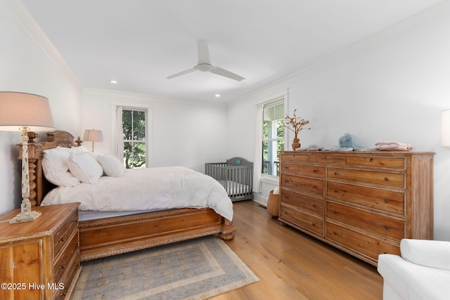 585 Forest Dunes Dr, Pine Knoll Shores, NC 28512 - bedroom with light wood finished floors, ornamental molding, radiator heating unit, recessed lighting, and a ceiling fan