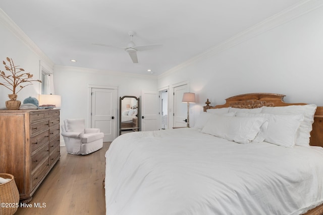 585 Forest Dunes Dr, Pine Knoll Shores, NC 28512 - bedroom with light wood-style floors, ornamental molding, ceiling fan, and recessed lighting