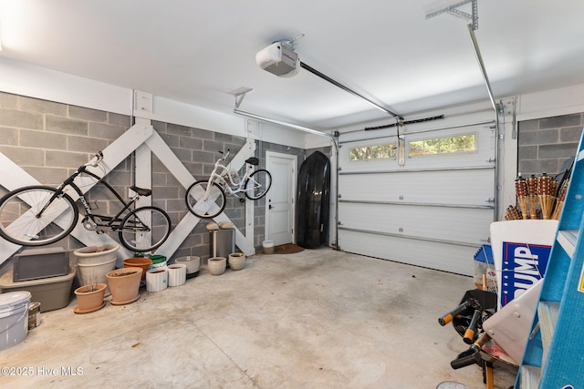 585 Forest Dunes Dr, Pine Knoll Shores, NC 28512 - garage featuring a garage door opener and concrete block wall