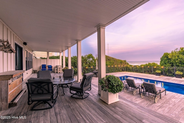 585 Forest Dunes Dr, Pine Knoll Shores, NC 28512 - deck at dusk with a fenced backyard and outdoor dining area