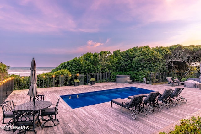 585 Forest Dunes Dr, Pine Knoll Shores, NC 28512 - view of swimming pool featuring a deck with water view and a hot tub