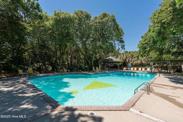 585 Forest Dunes Dr, Pine Knoll Shores, NC 28512 - community pool with a gazebo, a patio area, and view of scattered trees
