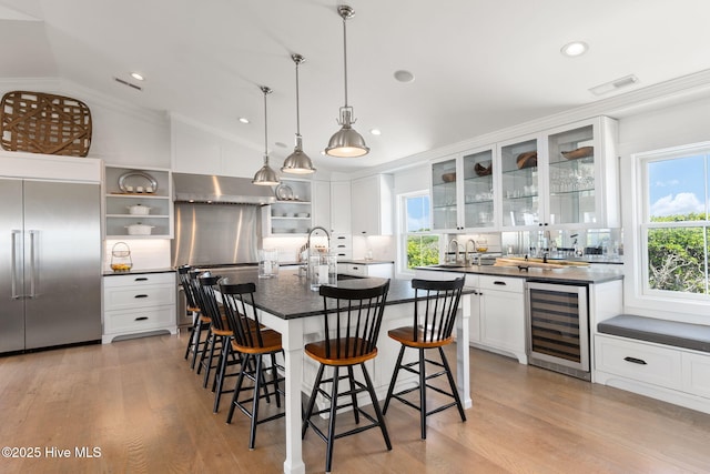 585 Forest Dunes Dr, Pine Knoll Shores, NC 28512 - kitchen featuring beverage cooler, stainless steel built in fridge, open shelves, dark countertops, and lofted ceiling
