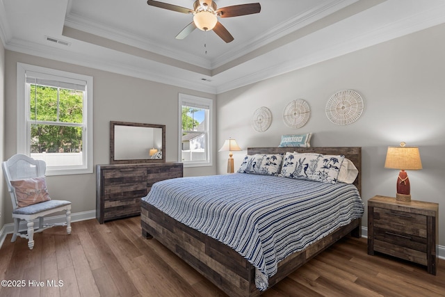 163 NE 31st St, Oak Island, NC 28465 - bedroom featuring multiple windows, wood finished floors, baseboards, and ornamental molding