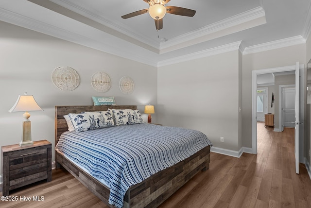 163 NE 31st St, Oak Island, NC 28465 - bedroom featuring a raised ceiling, wood finished floors, baseboards, and ornamental molding