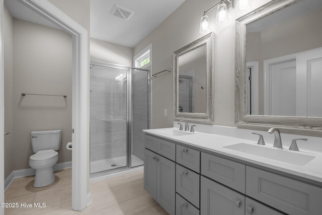 163 NE 31st St, Oak Island, NC 28465 - full bathroom featuring double vanity, a shower stall, toilet, and baseboards