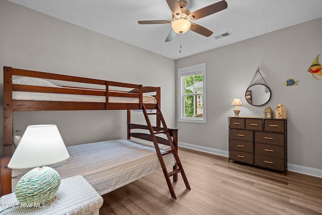 163 NE 31st St, Oak Island, NC 28465 - bedroom featuring light wood-type flooring, baseboards, and ceiling fan