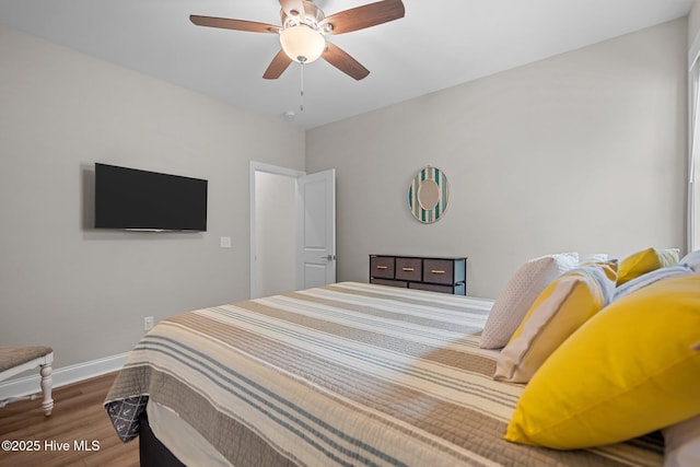 163 NE 31st St, Oak Island, NC 28465 - bedroom with wood finished floors, baseboards, and ceiling fan
