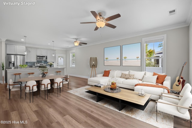 163 NE 31st St, Oak Island, NC 28465 - living room featuring crown molding, ceiling fan, light wood-type flooring, recessed lighting, and baseboards