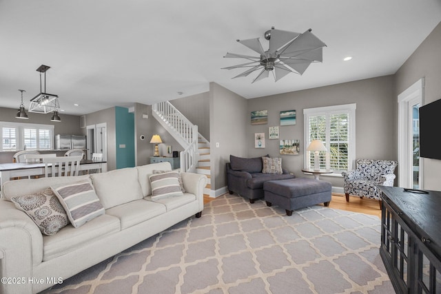 102 Seaside Ln, North Topsail Beach, NC 28460 - living area featuring stairway, a ceiling fan, wood finished floors, and recessed lighting