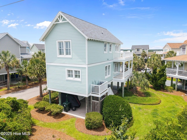 102 Seaside Ln, North Topsail Beach, NC 28460 - rear view of house featuring roof with shingles and a balcony