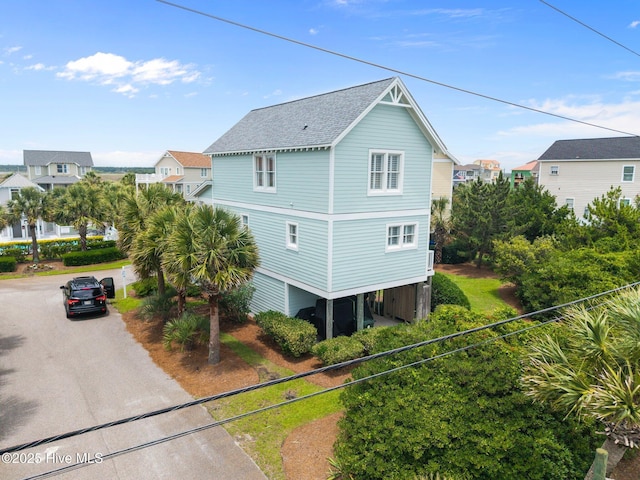 102 Seaside Ln, North Topsail Beach, NC 28460 - view of side of property with roof with shingles