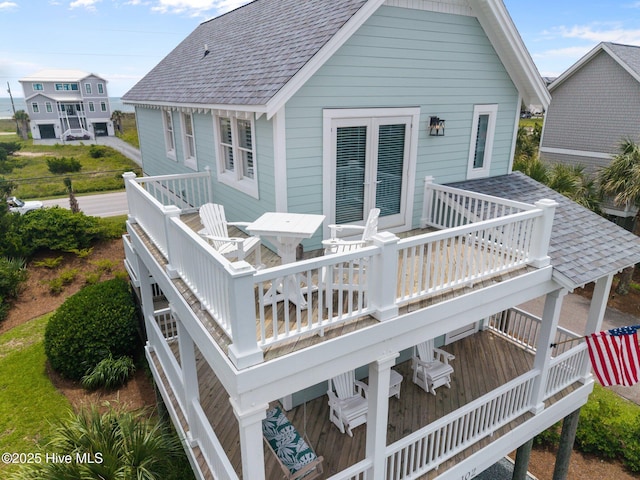 102 Seaside Ln, North Topsail Beach, NC 28460 - rear view of house featuring a wooden deck, a shingled roof, and outdoor dining area