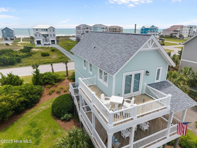 102 Seaside Ln, North Topsail Beach, NC 28460 - back of property featuring roof with shingles and a deck with water view