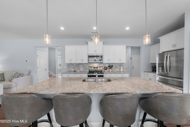 74 W Weatherbee Way, Hampstead, NC 28443 - kitchen featuring appliances with stainless steel finishes, a sink, tasteful backsplash, white cabinets, and recessed lighting