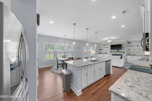 74 W Weatherbee Way, Hampstead, NC 28443 - kitchen with appliances with stainless steel finishes, open floor plan, a sink, dark wood finished floors, and white cabinetry
