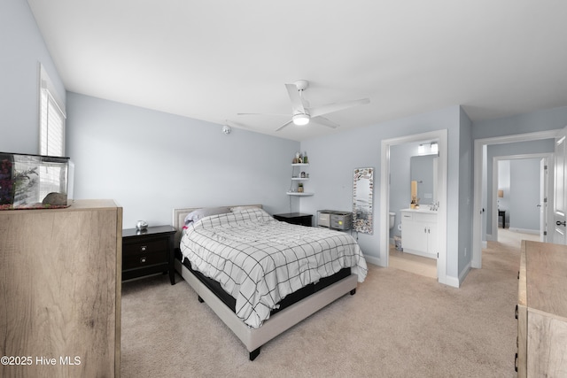 74 W Weatherbee Way, Hampstead, NC 28443 - bedroom with light colored carpet, baseboards, a ceiling fan, and ensuite bathroom