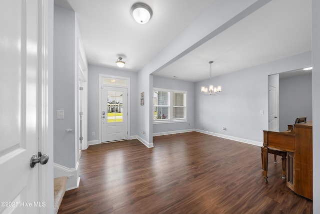 74 W Weatherbee Way, Hampstead, NC 28443 - foyer with a chandelier, dark wood finished floors, and baseboards