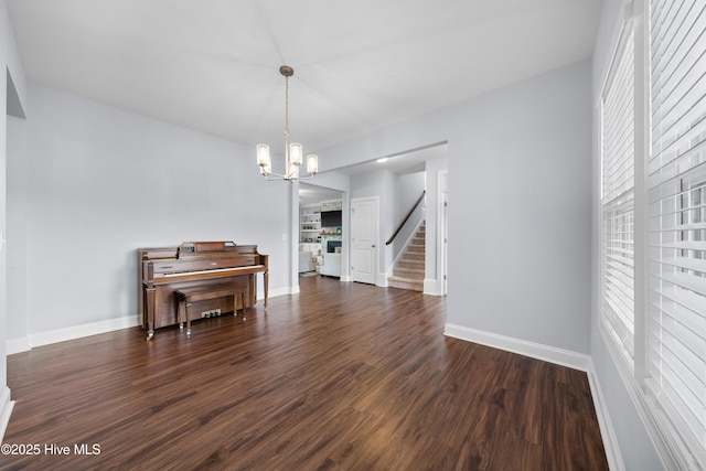 74 W Weatherbee Way, Hampstead, NC 28443 - dining area featuring a chandelier, dark wood-style floors, and baseboards