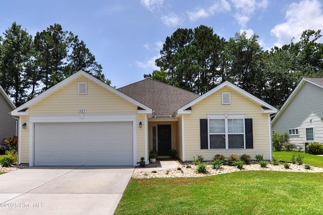 867 Corn Planters Cir, Calabash, NC 28467 - view of front of home with a front yard, concrete driveway, a garage, and roof with shingles