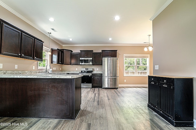 514 Everett Glades, Sneads Ferry, NC 28460 - kitchen featuring appliances with stainless steel finishes, light wood-style flooring, light countertops, dark brown cabinets, and crown molding