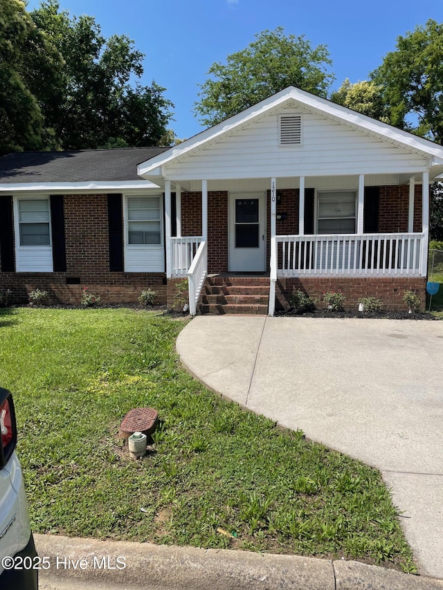 1210 Fayetteville St, Smithfield, NC 27577 - ranch-style house featuring brick siding, covered porch, and a front yard
