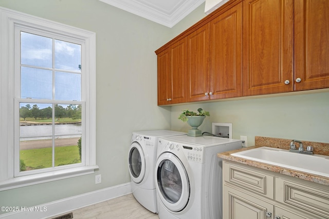249 Maple Creek Dr, Wallace, NC 28466 - laundry room with cabinet space, washer and dryer, crown molding, and a water view