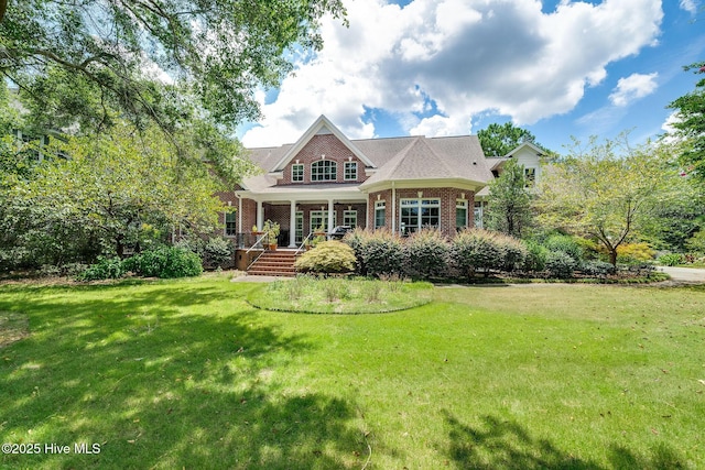 249 Maple Creek Dr, Wallace, NC 28466 - back of house featuring brick siding, a lawn, and covered porch