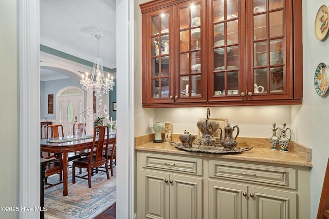 249 Maple Creek Dr, Wallace, NC 28466 - indoor bar with arched walkways, ornamental molding, a chandelier, and pendant lighting