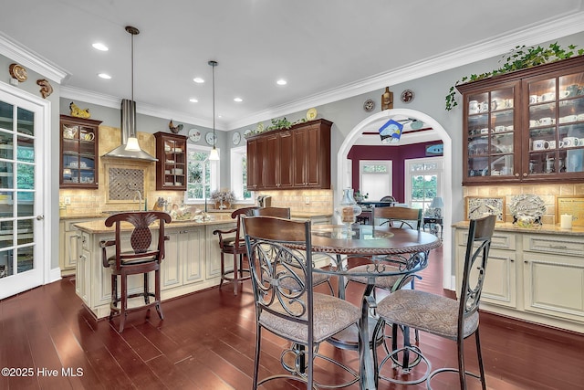 249 Maple Creek Dr, Wallace, NC 28466 - dining area featuring plenty of natural light, arched walkways, recessed lighting, dark wood-style flooring, and ornamental molding