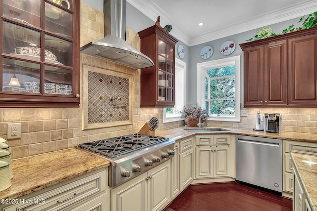 249 Maple Creek Dr, Wallace, NC 28466 - kitchen with stainless steel appliances, wall chimney range hood, cream cabinetry, ornamental molding, and light stone counters