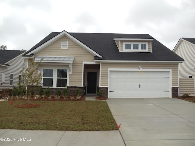 8711 Baton Rouge Ave NW Lot 1156, Calabash, NC 28467 - craftsman house featuring concrete driveway, an attached garage, a front lawn, stone siding, and a shingled roof