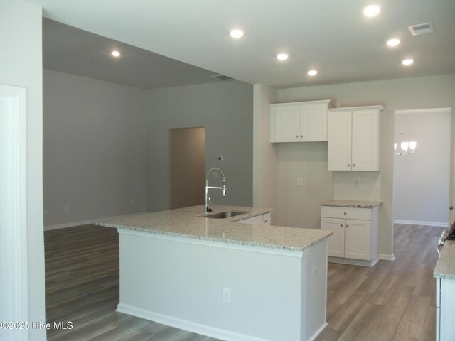 8711 Baton Rouge Ave NW Lot 1156, Calabash, NC 28467 - kitchen featuring a sink, light wood finished floors, white cabinets, an island with sink, and recessed lighting