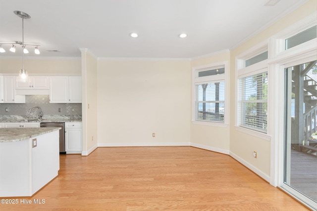 8630 Sound Dr Unit B2, Emerald Isle, NC 28594 - kitchen with stainless steel dishwasher, light wood finished floors, plenty of natural light, crown molding, and recessed lighting