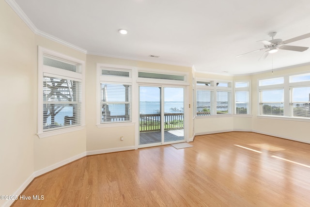 8630 Sound Dr Unit B2, Emerald Isle, NC 28594 - unfurnished sunroom featuring ornamental molding, wood finished floors, a water view, and recessed lighting