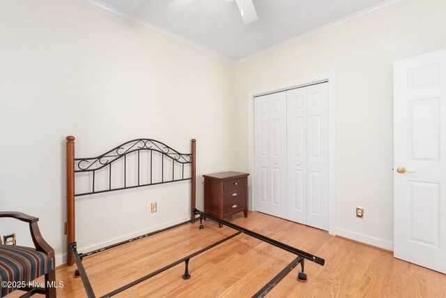 8630 Sound Dr Unit B2, Emerald Isle, NC 28594 - bedroom featuring light wood-style flooring, crown molding, a closet, and a ceiling fan
