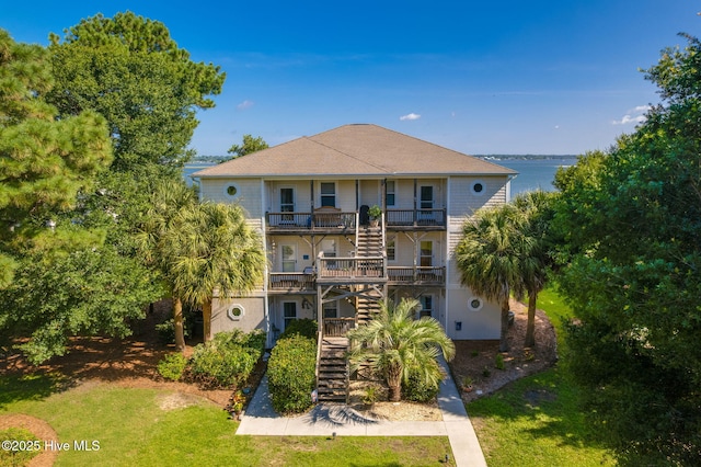 8630 Sound Dr Unit B2, Emerald Isle, NC 28594 - back of house featuring stairway, a yard, a balcony, and a water view