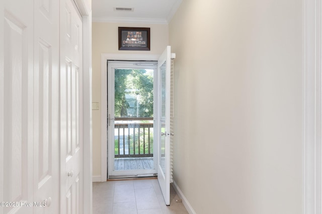 8630 Sound Dr Unit B2, Emerald Isle, NC 28594 - doorway to outside with crown molding and light tile patterned floors