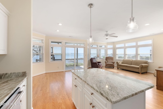 8630 Sound Dr Unit B2, Emerald Isle, NC 28594 - kitchen featuring open floor plan, light wood-style floors, a ceiling fan, crown molding, and recessed lighting
